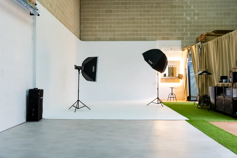 Setup de fotografía profesional en ciclorama con trípodes y equipos de iluminación LED